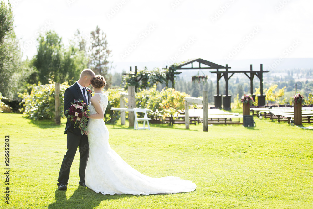 Young bride and groom embracing at vineyard Young bride and groom embracing at vineyard