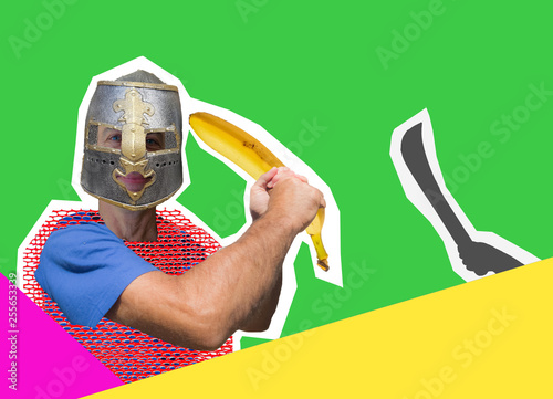 Fotografie Comic knight with a banana instead of a sword is protected from a fictional enemy