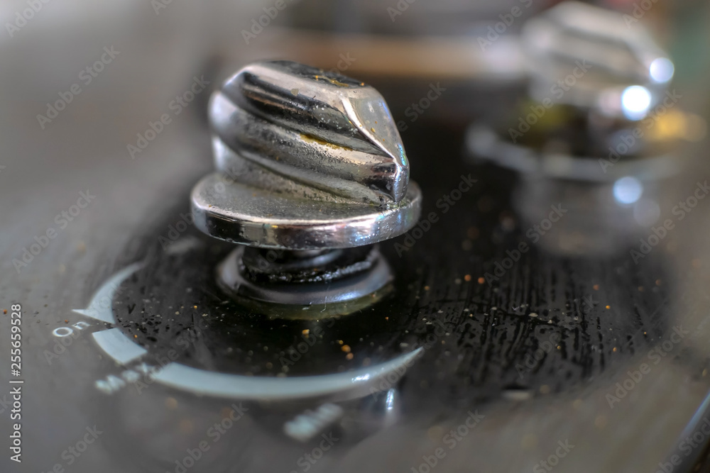 dirty and oily knob of a kitchen stove, close up selective focusing dirty and oily knob of a kitchen stove, close up selective focusing