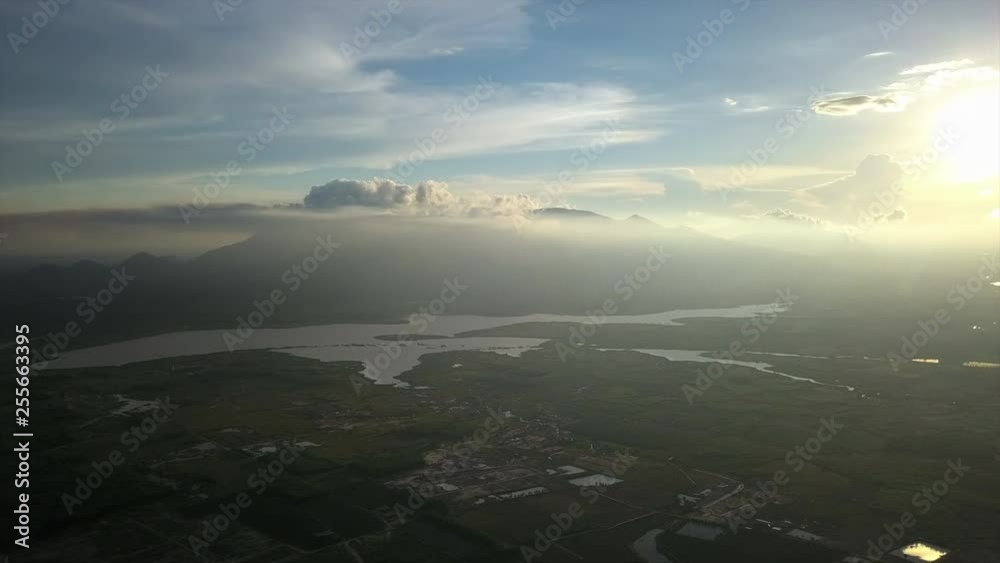 Gorgeous high altitude aerial shot of the sun high in the sky looking over the scenery below.