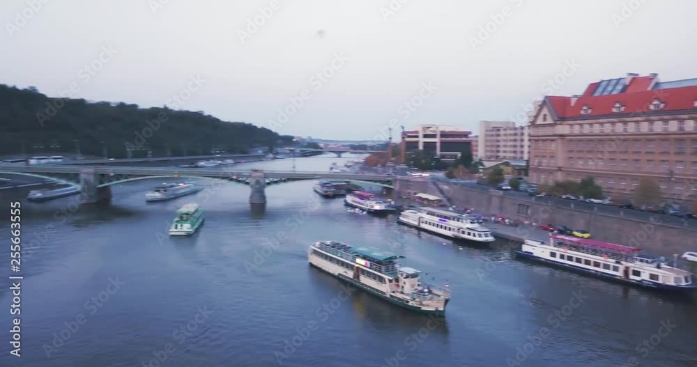 Aerial drone Moving to the Left revealing the Vltava River with boats and bridges around in the city of Prage, Czech Republic Aerial drone Moving to the Left revealing the Vltava River with boats and bridges around in the city of Prage, Czech Republic