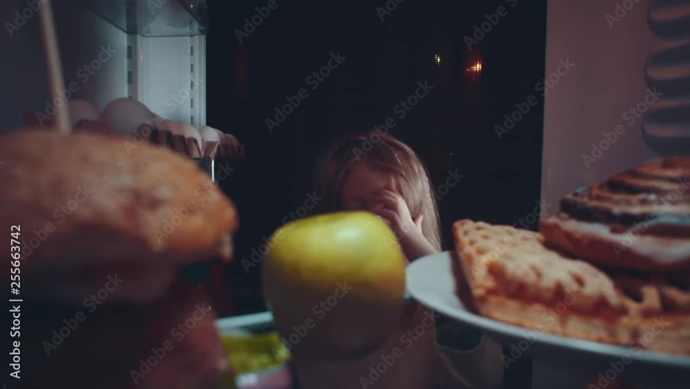 Vidéo Stock Little cute baby takes food out of the refrigerator at