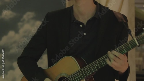 musician is playing on guitar (close-up)