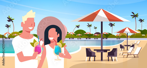 happy couple drinking cocktails relaxing by swimming pool man woman having fun together summer vacation concept landscape background flat portrait