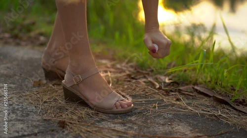 Closeup shot of a beautiful young woman applying an antimosquito repellent spray on her skin. A tropical background. Mosquito defense concept photo