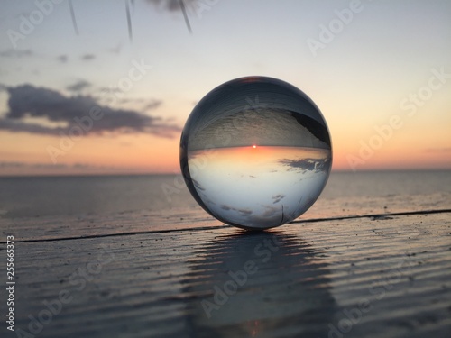 Glass ball reflection of tropical sunset. © VSujatha
