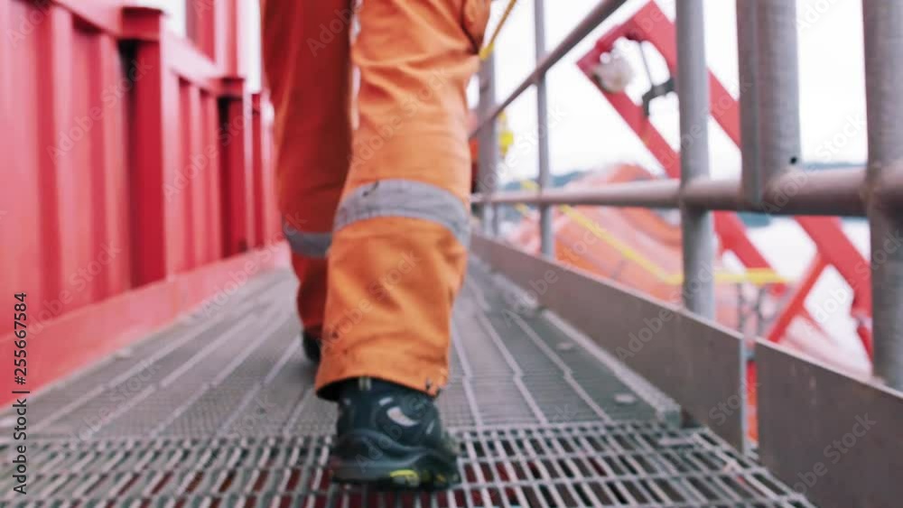 Offshore oil worker walking on oil platform.