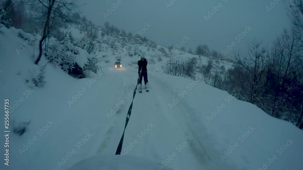 skier being pulled by an off-road car 4 skier being pulled by an off-road car 4
