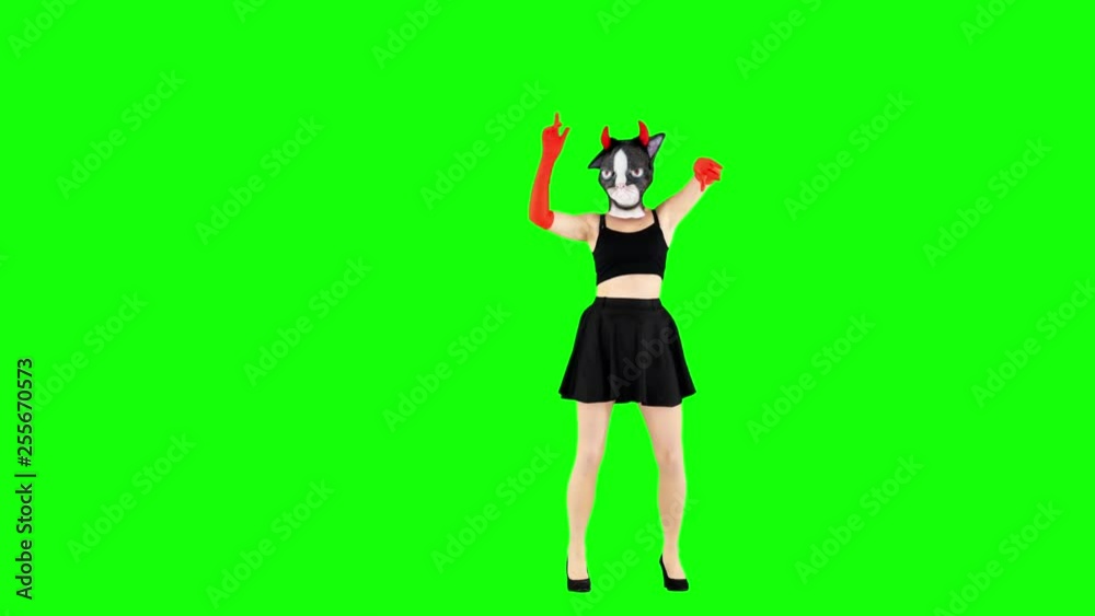 Funny Girl Dancing in Latex Cat Mask and Devil Horns. Halloween Concept Funny Girl Dancing in Latex Cat Mask and Devil Horns. Halloween Concept