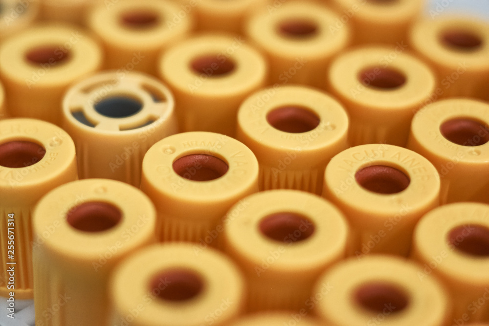 macro of test tubes with yellow top, against a gradient of white background. Concept of good health macro of test tubes with yellow top, against a gradient of white background. Concept of good health