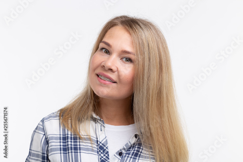 Teeth health, dentistry and bite correction - Happy smiling woman with braces on white background