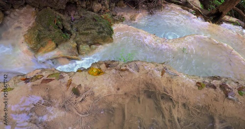 Clean fresh water stream in tropics flows on cascades. Geoligical formations in Thailand rainforest photo