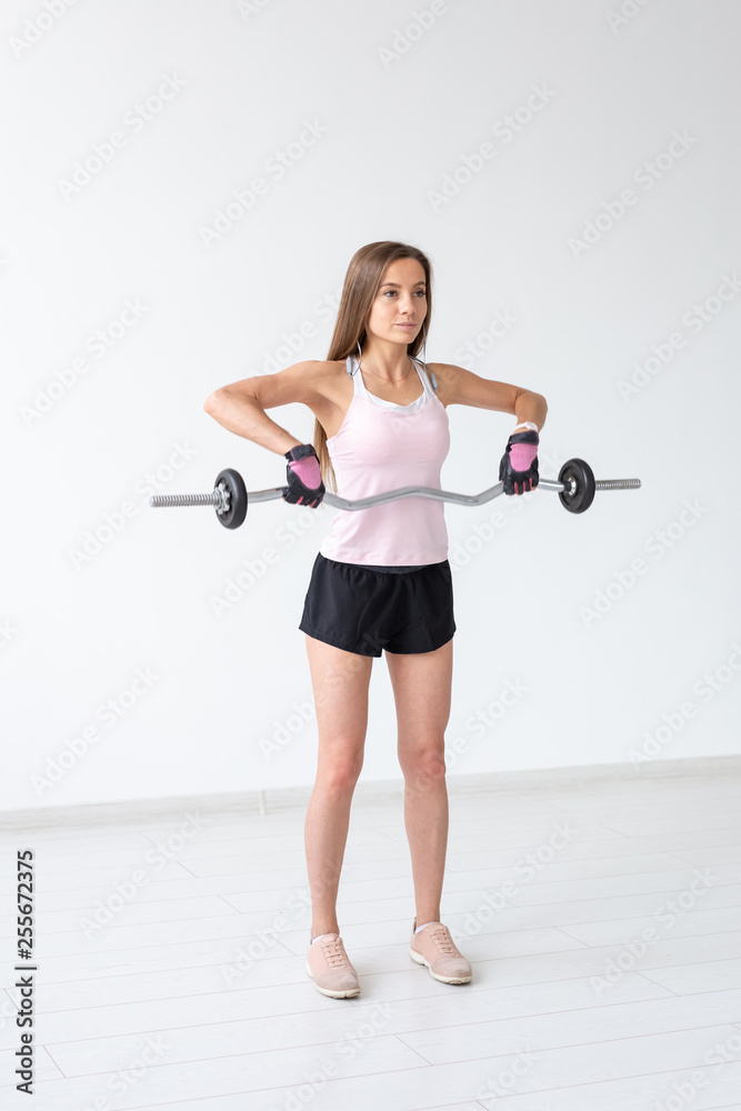 Obraz premium Healthy lifestyle, fitness, people and sport concept - Close up portrait of fit woman in pink shirt workout with body bar