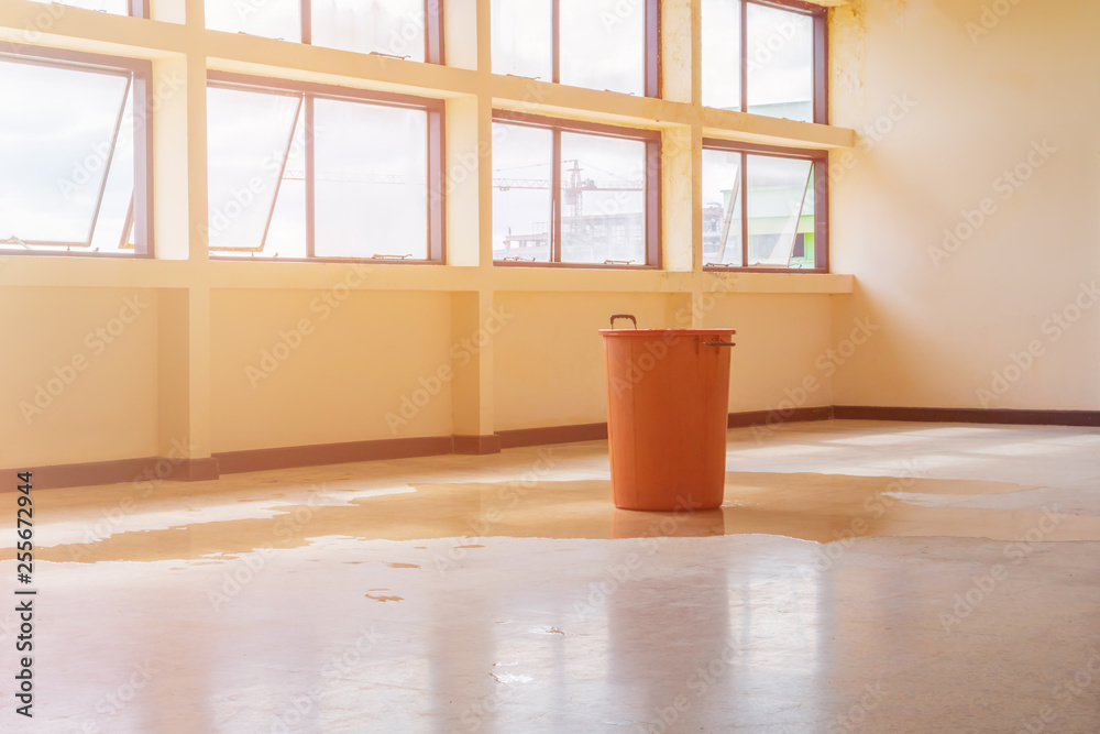 water leak drop interior office building in red bucket from Ceiling and ...