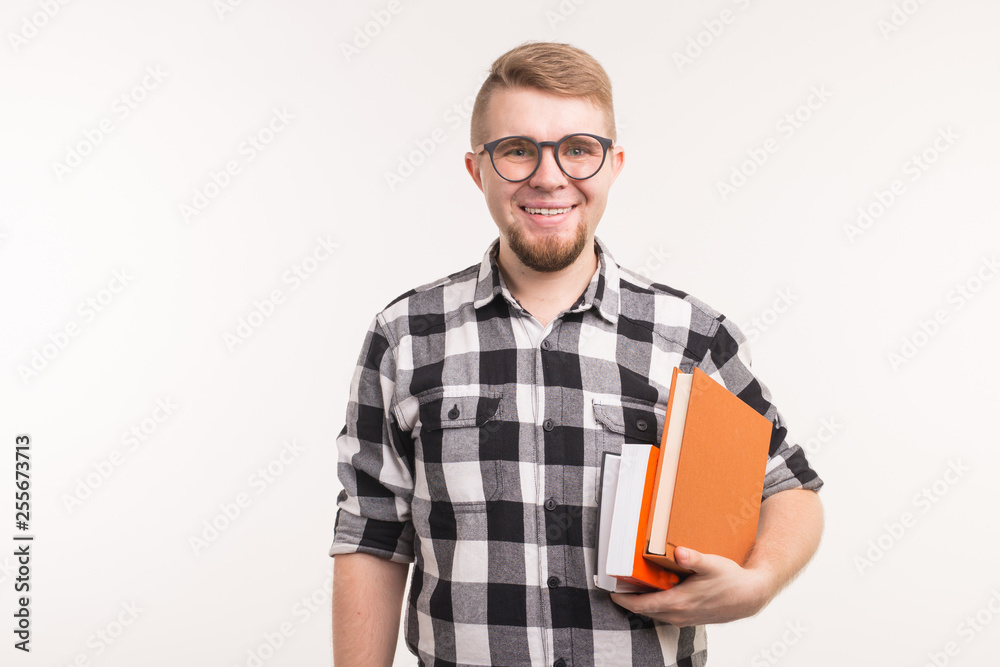 People, knowledge and education concept - Portrait of happy man holding books in his hands People, knowledge and education concept - Portrait of happy man holding books in his hands