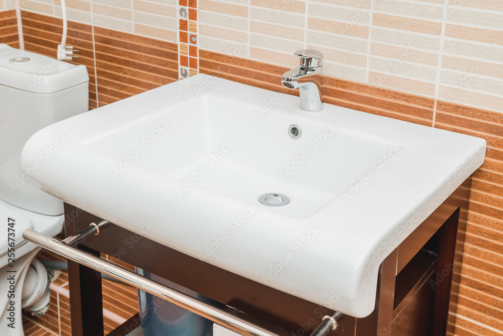 The photo of a sink in a bathroom The photo of a sink in a bathroom