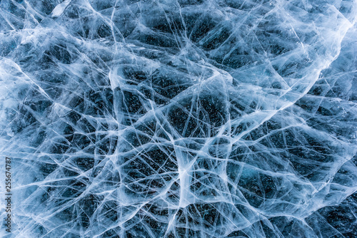 Ice crack texture, Close-up texture surface cracks of the natural ice in frozen water at Baikal lake, Russia.