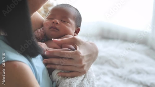 Close up portrait of beautiful young mother asian carrying little baby girl in home and sunlight in the morning. Healthcare, love, relationship concept