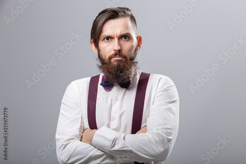 people, fashion and style concept - close-up portrait of young hipster on grey background © satura_