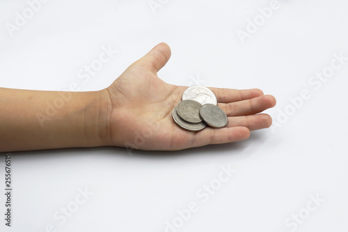 Kid hand showing money coins , child holding a coins on his hand isolate on white background, saving money for the future.
