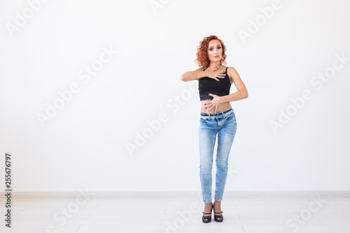 People and fashion concept - Attractive woman in a black top posing over white background with copy space