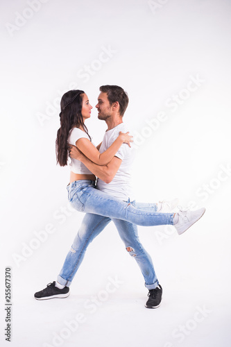 Passionate couple dancing social danse kizomba or bachata or semba or taraxia on white background