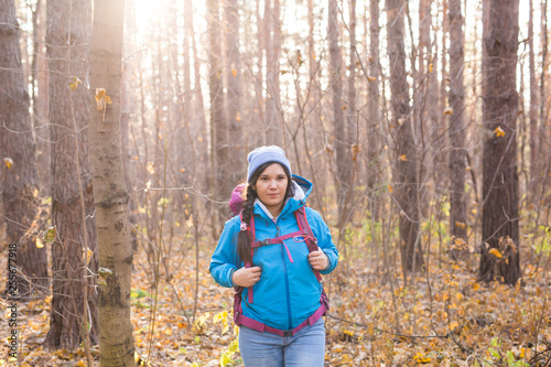 People  hike and nature concept - Female tourist walking in the autumn forest