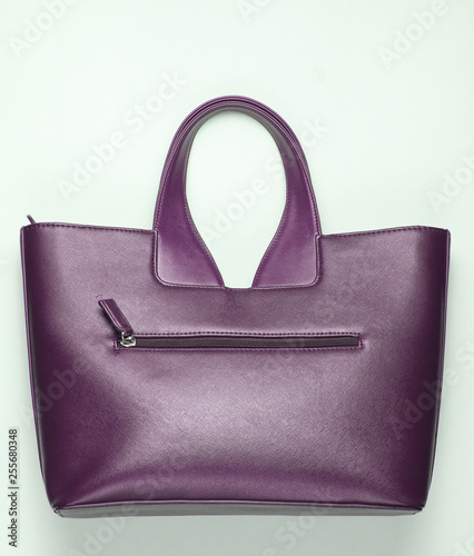 Leather fashionable handbag on grray background. top view. Minimalism photo