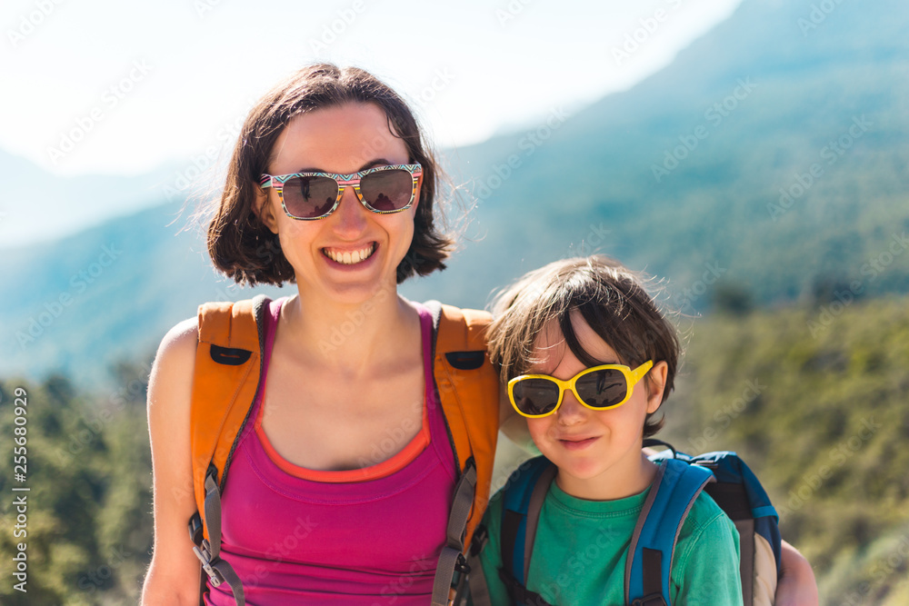 The boy and his mother are sitting on the top of the mountain. The boy and his mother are sitting on the top of the mountain.