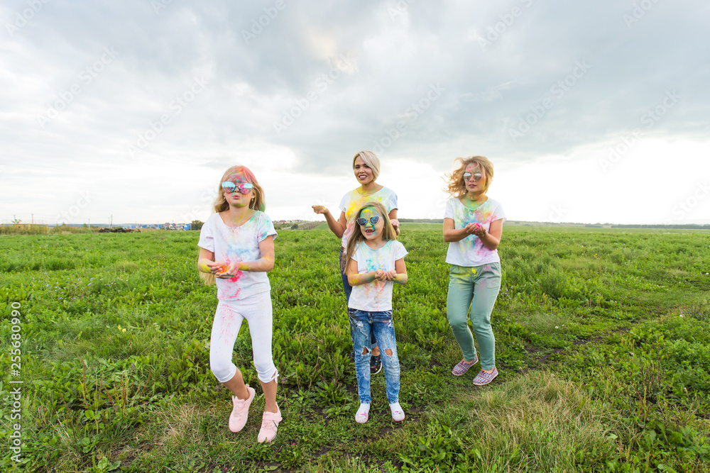 Holi festival, holidays and happiness concept - young teens and women in colors have fun outdoor Holi festival, holidays and happiness concept - young teens and women in colors have fun outdoor