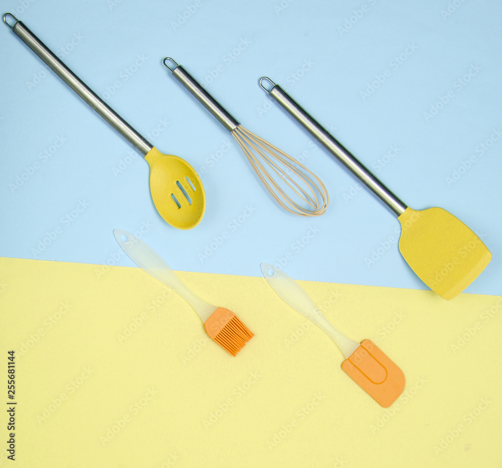 Kitchen utensils set : culinary brush, whisk, spatula on pastel background. Top view, minimalism Kitchen utensils set : culinary brush, whisk, spatula on pastel background. Top view, minimalism
