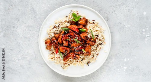teriyaki chicken's  with chili pepper and sesame seeds, with rice. on a white plate, copy space, selective focus, Asian cuisine, Chinese cuisine, Thai cuisine. food flat lay. light background