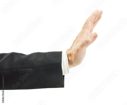 Man in a suit reaches his hand out with open palm for warning gesture isolated on white background