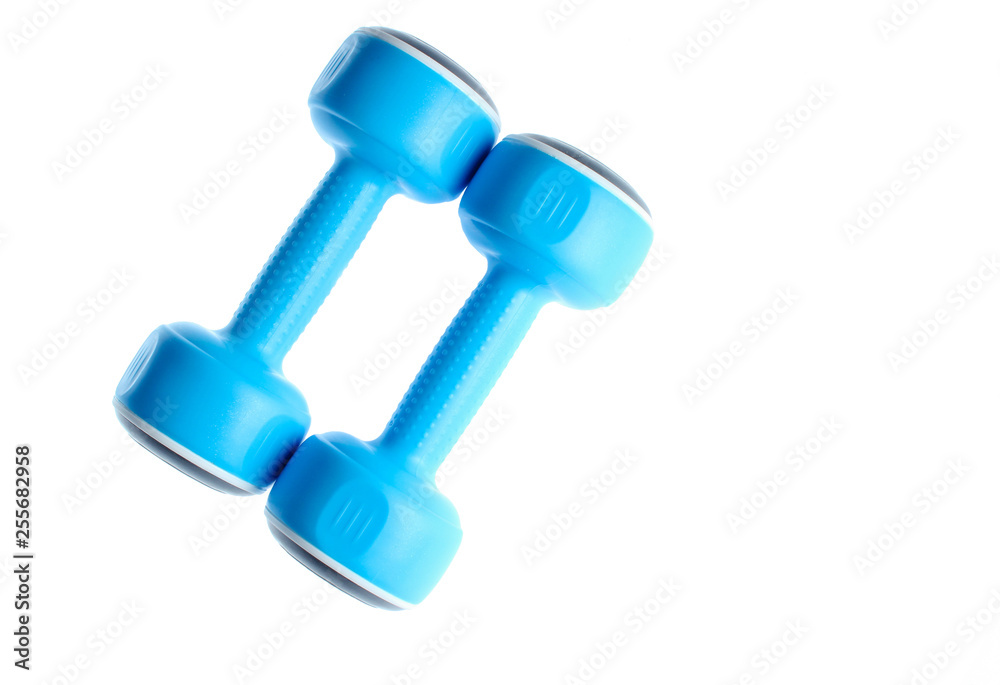 Two plastic blue dumbbells isolated on a white background. Sports concept. Two plastic blue dumbbells isolated on a white background. Sports concept.