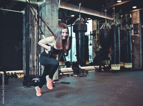 Fit woman doing exercise with strap at gym, workout, functional training. Sports lifestyle © splitov27