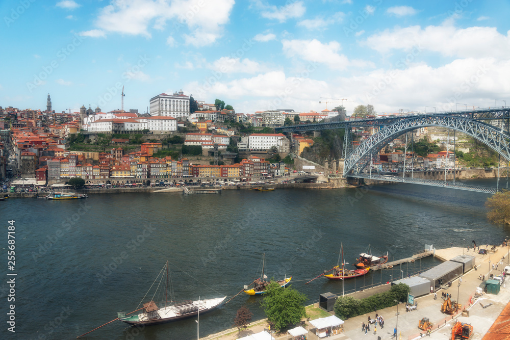  Ancient boats on Douro River. Dom Luis Bridge. Porto, Portugal.
