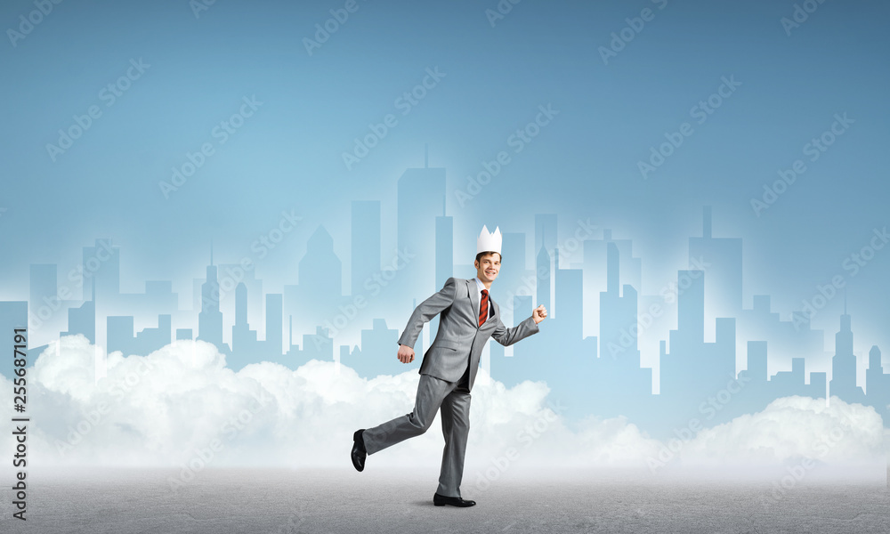 King businessman in elegant suit running and blue cityscape silhouette at background King businessman in elegant suit running and blue cityscape silhouette at background