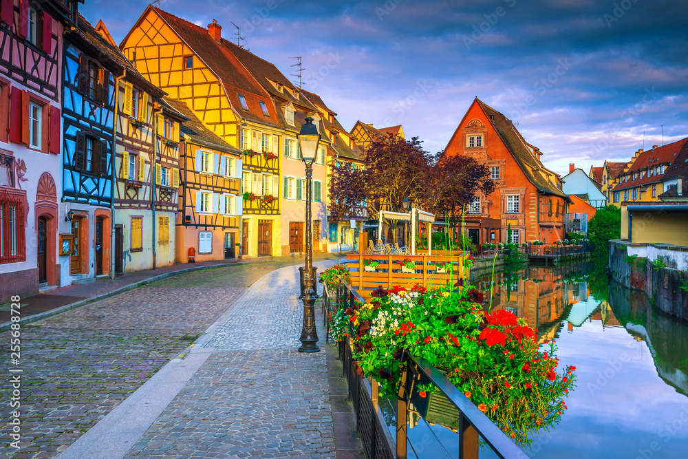 Medieval colorful facades reflecting in water at morning, Colmar, France