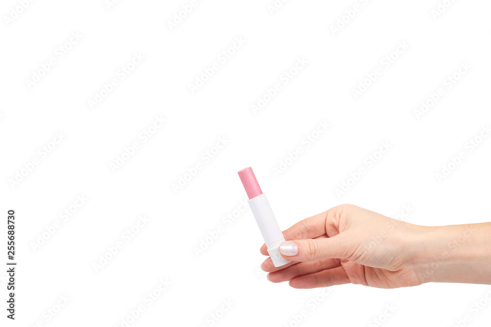 Obraz Hand with pink balm lipstick, lips care and beauty