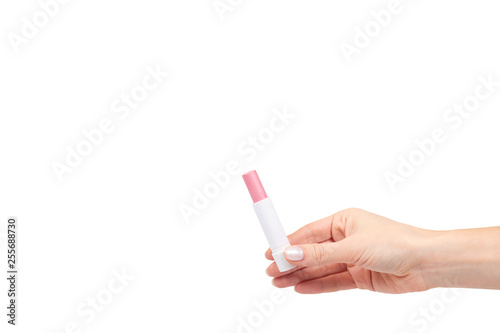 Cuadro en lienzo Hand with pink balm lipstick, lips care and beauty