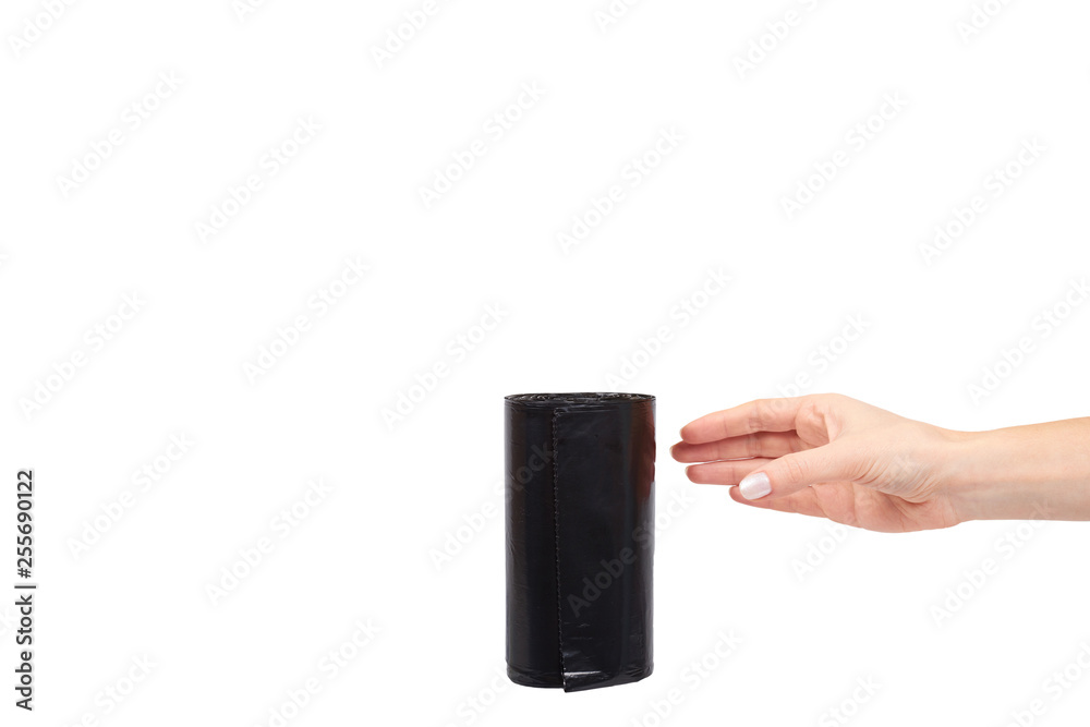 hand with roll of black plastic garbage bags for trash hand with roll of black plastic garbage bags for trash