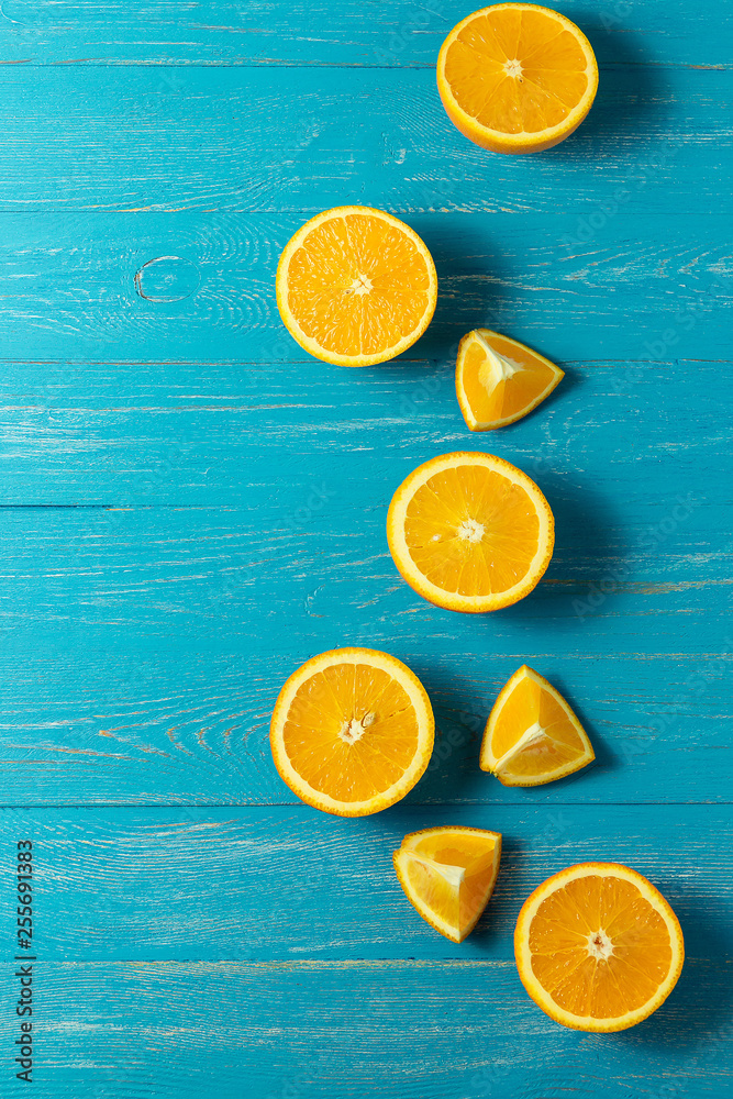 Row of fresh oranges, top view. Healthy citrus fruits on blue wooden background, top view, copyspace. Row of fresh oranges, top view. Healthy citrus fruits on blue wooden background, top view, copyspace.