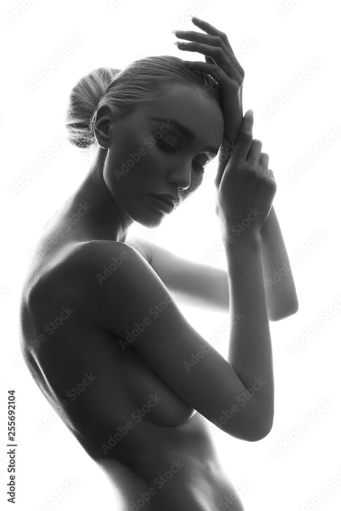 Fototapeta premium Graceful art Nude girl blonde erotic posing, clean smooth skin, thoughtful look of a woman. Large natural Breasts. Naked woman with perfect body on white background, isolate