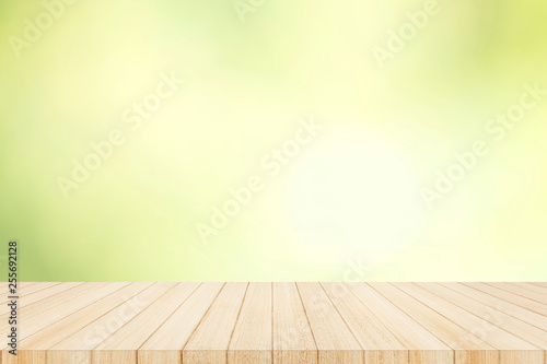 Wood table top on with blur glass window wall background.