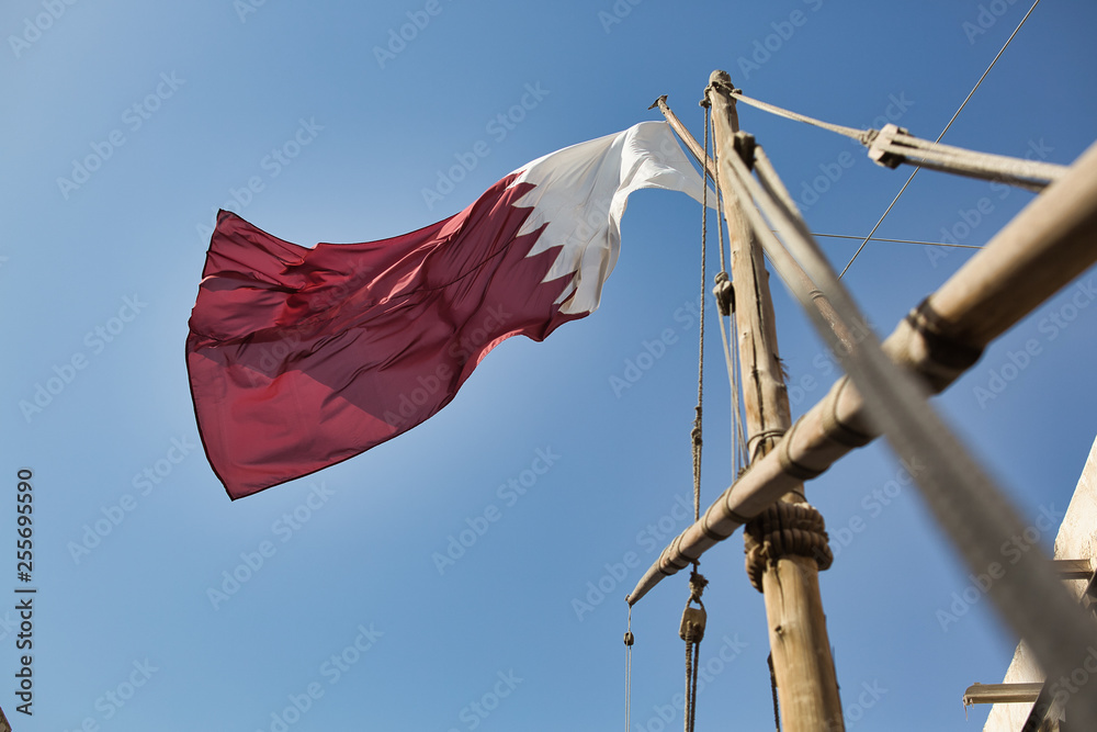 Φωτογραφία Flag of Qatar waving in the wind with the blue sky background