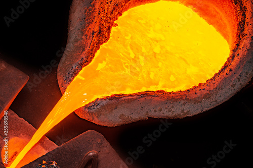 metal casting process with high temperature fire in metal part factory photo