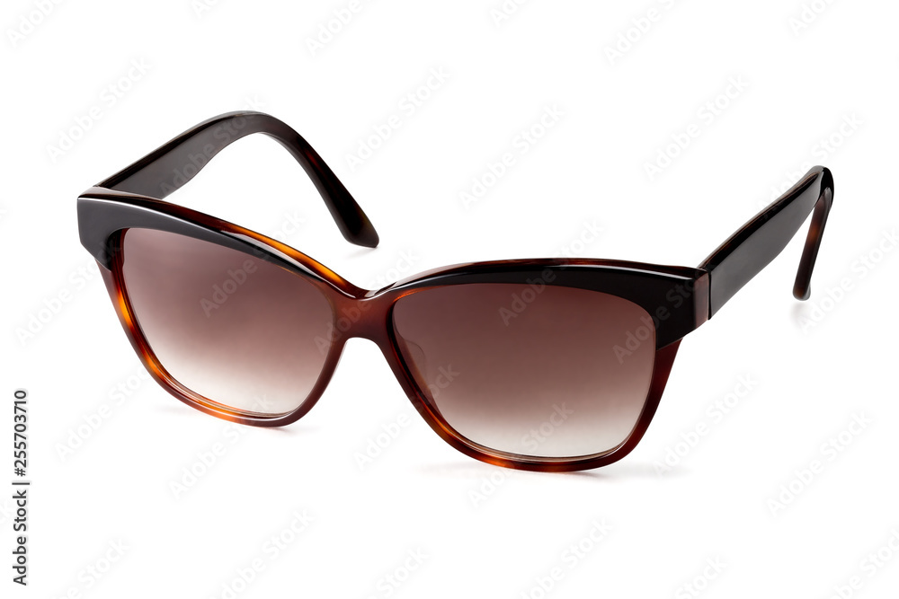 Stylish women's brown sunglasses on a white background. In half a turn. Stylish women's brown sunglasses on a white background. In half a turn.