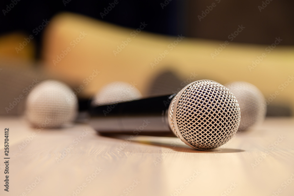 Closeup silver iron microphones with black handle on the table. Concept live music in restaurant, bar in the evening, sing in karaoke, concert, conference, performance, speech