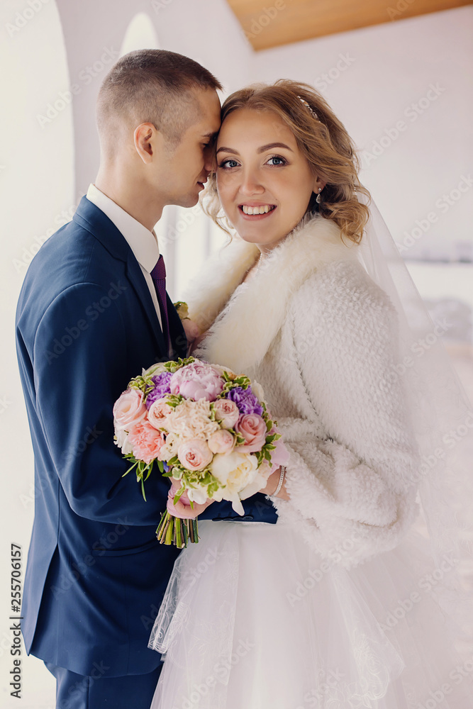 the newlyweds gently look at each other.the bride and groom gently hugging indoors.brides in a wedding ceremony in a stylish interior.weeding day.weeding concept the newlyweds gently look at each other.the bride and groom gently hugging indoors.brides in a wedding ceremony in a stylish interior.weeding day.weeding concept