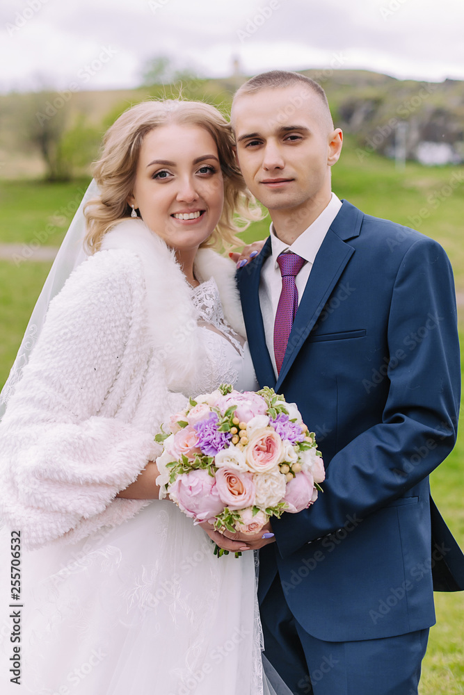 Autumn portrait of newlyweds in love, on a background of green trees on nature. Wedding photography. Autumn portrait of newlyweds in love, on a background of green trees on nature. Wedding photography.